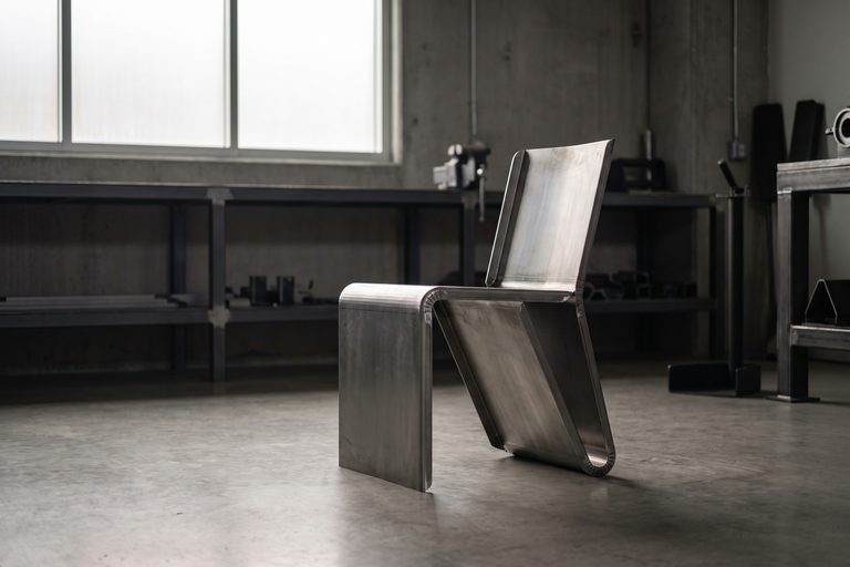 A chair bent from one sheet of steel