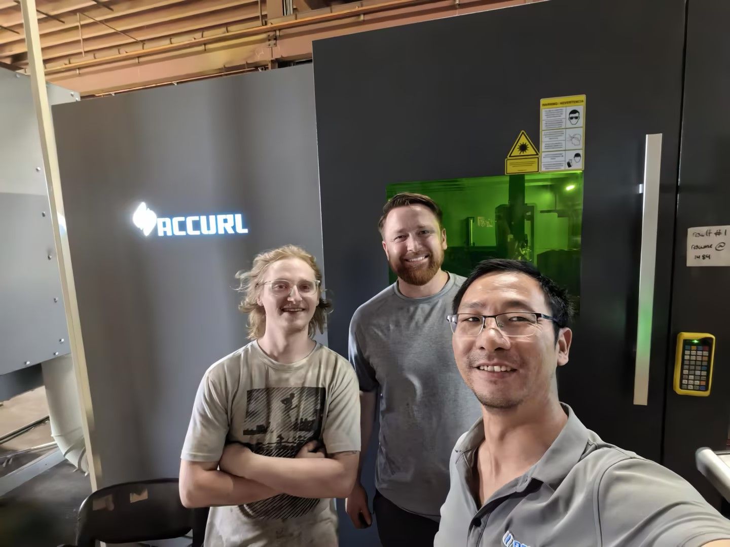 An Accurl service engineer with the customer's operators at the machine after the repair